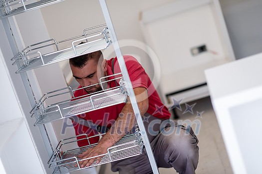young professional worker installing a new stylish modern kitchen furniture young professional worker installing a new stylish modern kitchen furniture