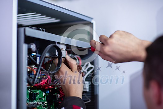 Closeup of electrician engineer working with electric cable wires of modern fuse switch box. Electrical equipment adjusting new voltage wiring Closeup of electrician engineer working with electric cable wires of modern fuse switch box. Electrical equipment adjusting new voltage wiring