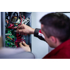 Closeup of electrician engineer working with electric cable wires of modern fuse switch box. Electrical equipment adjusting new voltage wiring