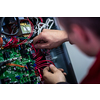 Closeup of electrician engineer working with electric cable wires of modern fuse switch box. Electrical equipment adjusting new voltage wiring