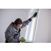 service man installing window with measure tape Man measuring window before installation of roller shutter