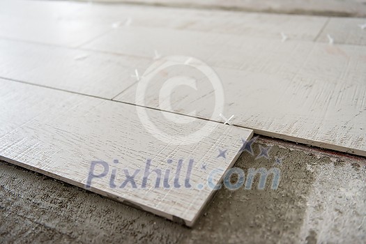 Ceramic wood effect tiles and tools for tiler on the floor unfinished laying floor tiles Floor tiles installation Ceramic wood effect tiles and tools for tiler on the floor unfinished laying floor tiles Floor tiles installation