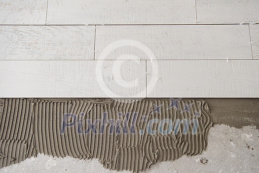 Ceramic wood effect tiles and tools for tiler on the floor unfinished laying floor tiles Floor tiles installation Ceramic wood effect tiles and tools for tiler on the floor unfinished laying floor tiles Floor tiles installation
