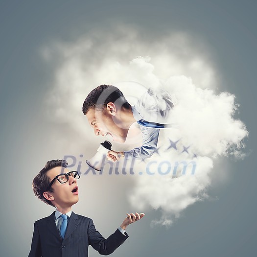 Funny young man with big head screaming emotionally in megaphone on his boss Funny young man with big head screaming emotionally in megaphone on his boss