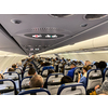 Cabin of a modern airplane filled with passangers to its full capacity during flight, after delayed departure (shallow DOF)