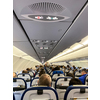 Cabin of a modern airplane filled with passangers to its full capacity during flight, after delayed departure (shallow DOF)