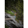 Pretty, female climber on a via ferrata - climbing on a rock in Swiss Alps