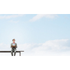 Young businessman wearing red bow tie sitting on bench with book in hands