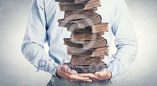 Close up of man holding pile of books in hands Close up of man holding pile of books in hands