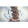 Close up of man holding pile of books in hands