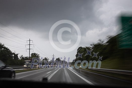 Cars on a highway at a rainy dusk (shallow DOF; color toned image) Cars on a highway at a rainy dusk (shallow DOF; color toned image)