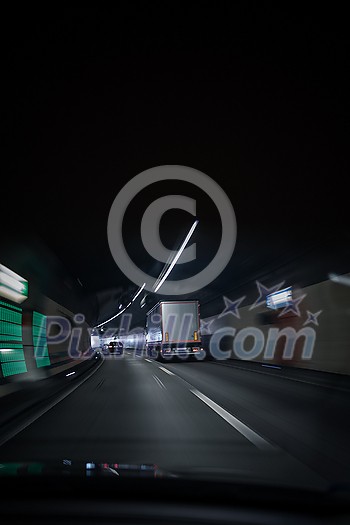 Cars on a highway going through a long modern tunnel (motion blurred image; color toned image) Cars on a highway going through a long modern tunnel (motion blurred image; color toned image)