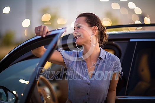 Pretty, young woman driving a car -Invitation to travel. Car rental, car ownership or vacation Pretty, young woman driving a car -Invitation to travel. Car rental, car ownership or vacation