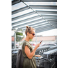 Pretty, young woman going grocery shopping with a trolley