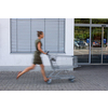 Pretty, young woman going grocery shopping with a trolley