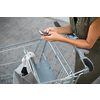 Pretty, young woman going grocery shopping with a trolley