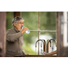 Handsome senior man drinking mineral water in a spa/health resort, enjoying its health benefits