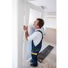 male workers carpenters installing interior glass door with a wooden frame at new luxury apartment