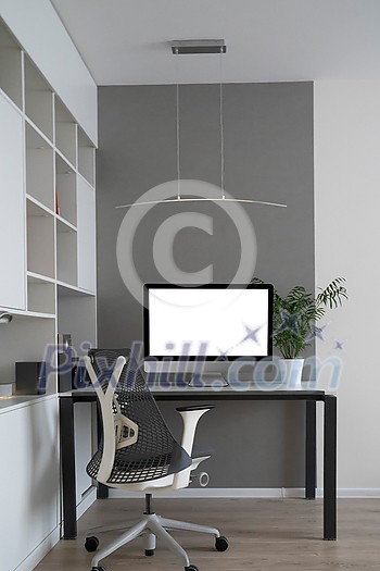 Modern mockup computer monitor on an office table and orthopaedic chair as a well-disigned comfortable working place with natural daylighting, copy space. Home office concept. Modern mockup computer monitor on an office table and orthopaedic chair as a well-disigned comfortable working place with natural daylighting, copy space. Home office concept.