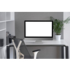 Daylight interior with white modern mock-up computer monitor on an office table, orthopaedic chair, and greenery pot on a desk, copy space. Concept of home remotely working.