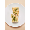Delicious homemade pancake rolled with filling from chicken, natural mushroom and white sauce on a ceramic plate on a pastel beige background, copy space. Top view.