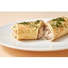 Homemade freshly cooked delicious roll pancake with filling from chicken and mushroom on a ceramic plate on a pastel beige background, copy space.