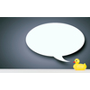 Young businesswoman and yellow rubber duck toy on table