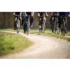 mixed group of cyclists biking