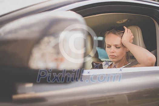 Pretty, young woman driving a car -Invitation to travel. Car rental or vacation. Pretty, young woman driving a car -Invitation to travel. Car rental or vacation.