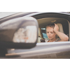 Pretty, young woman  driving a car -Invitation to travel. Car rental or vacation.