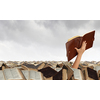 Hand with book reaching out from pile of old books