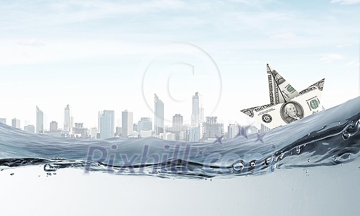 Ship made of dollar banknote floating in water Ship made of dollar banknote floating in water
