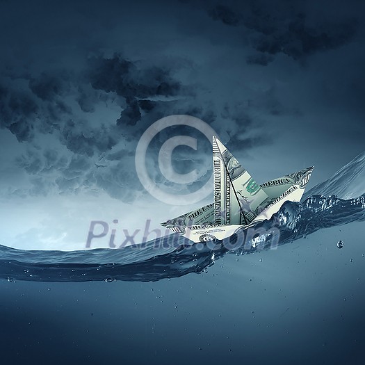 Ship made of dollar banknote floating in water Ship made of dollar banknote floating in water