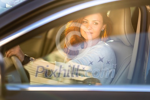 Pretty, young woman driving a car -Invitation to travel. Car rental or vacation. Pretty, young woman driving a car -Invitation to travel. Car rental or vacation.
