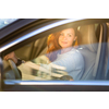 Pretty, young woman  driving a car -Invitation to travel. Car rental or vacation.