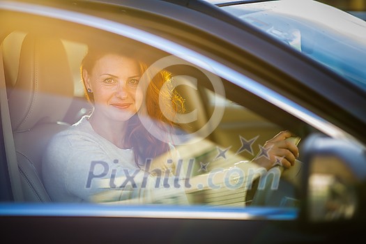 Pretty, young woman driving a car -Invitation to travel. Car rental or vacation. Pretty, young woman driving a car -Invitation to travel. Car rental or vacation.