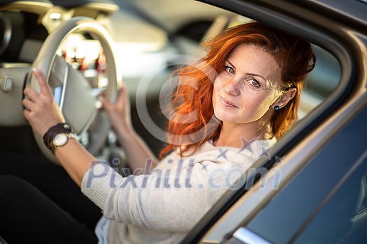 Pretty, young woman driving a car -Invitation to travel. Car rental or vacation. Pretty, young woman driving a car -Invitation to travel. Car rental or vacation.