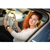 Pretty, young woman  driving a car -Invitation to travel. Car rental or vacation.