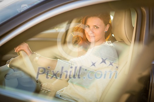 Pretty, young woman driving a car -Invitation to travel. Car rental or vacation. Pretty, young woman driving a car -Invitation to travel. Car rental or vacation.