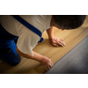 DIY, repair, building and home concept - close up of male hands lying parquet floor board/laminate flooring (shallow DOF; color toned image)