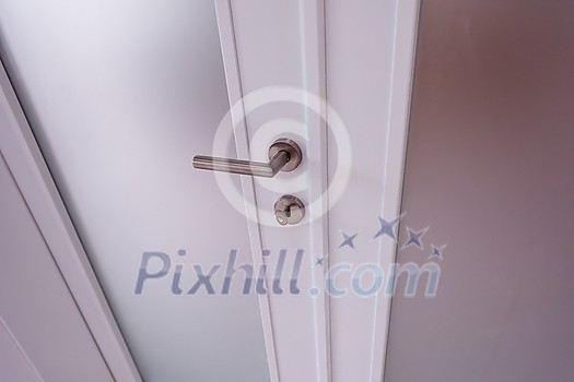 double glass door with white wooden frame in empty room interior double glass door with white wooden frame in empty room interior