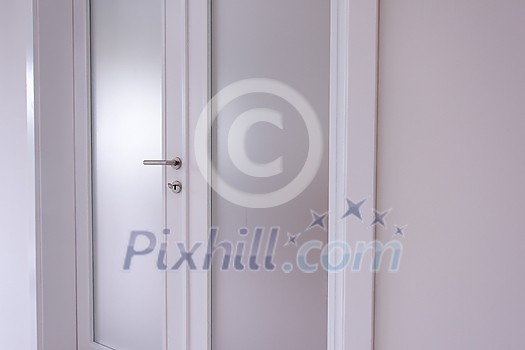 double glass door with white wooden frame in empty room interior double glass door with white wooden frame in empty room interior