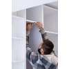 young professional worker writing the measures during installation a new stylish modern kitchen furniture