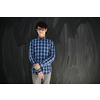 portrait  of smart looking arab teenager with glasses wearing a hat in casual school look against black chalkboard background