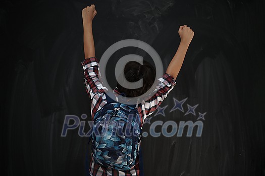 happy arab teenager celebrating wearing backpack casual school look against black chalkboard background happy arab teenager celebrating wearing backpack casual school look against black chalkboard background