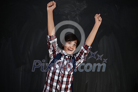 happy arab teenager celebrating wearing backpack casual school look against black chalkboard background happy arab teenager celebrating wearing backpack casual school look against black chalkboard background