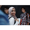 Arabic teenagers, students group  portrait against black chalkboard wearing backpack and books in school