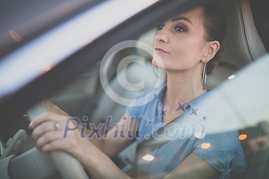 Pretty, young woman driving a car -Invitation to travel. Car rental or vacation. Pretty, young woman driving a car -Invitation to travel. Car rental or vacation.