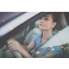 Pretty, young woman  driving a car -Invitation to travel. Car rental or vacation.
