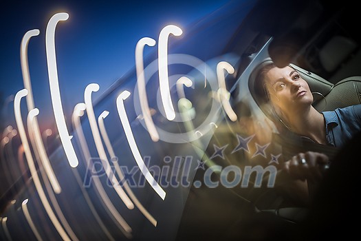 Pretty, young woman driving a car -Invitation to travel. Car rental, car ownership or vacation Pretty, young woman driving a car -Invitation to travel. Car rental, car ownership or vacation